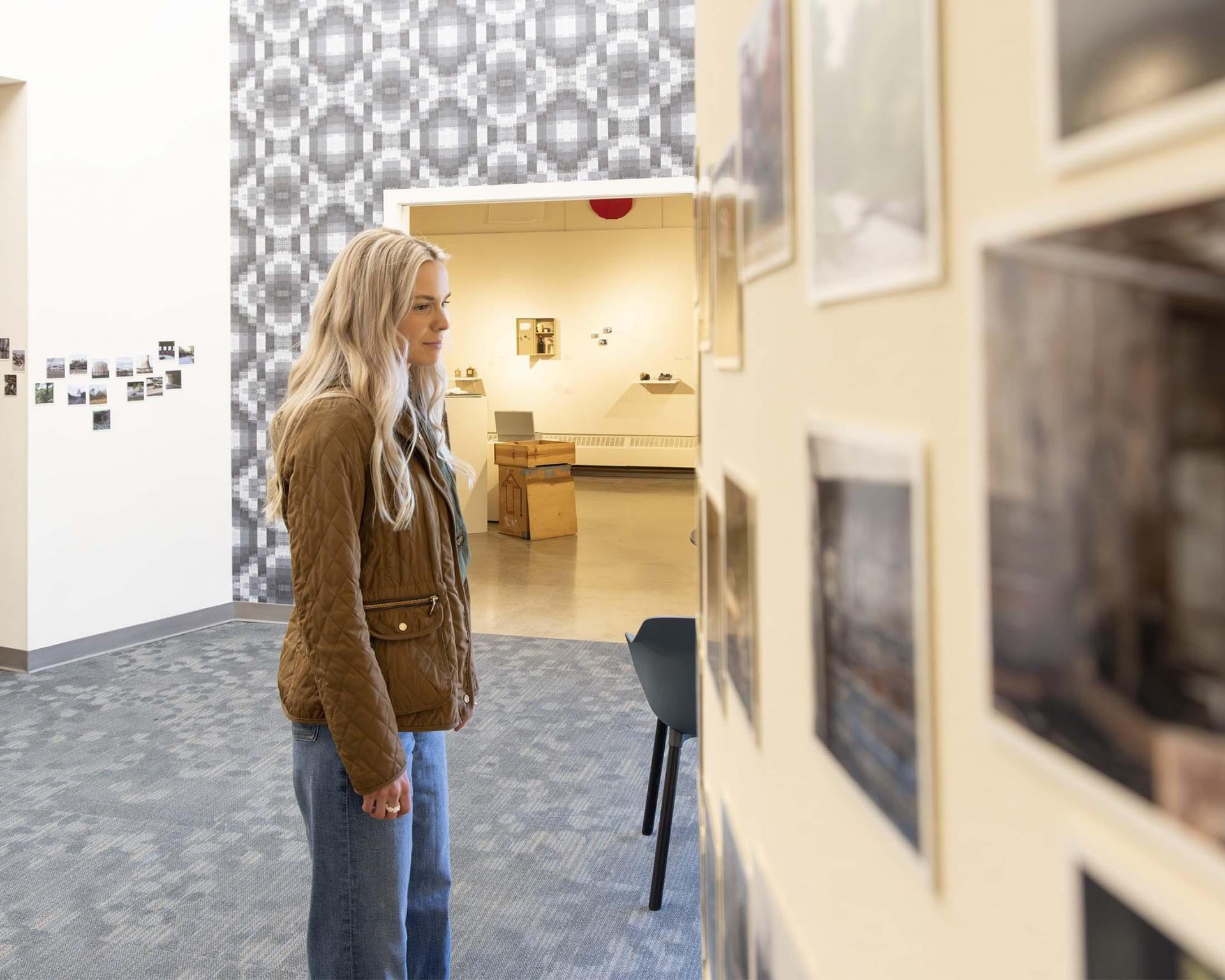 A person looking at an exhibit at the Krasl Art Center.