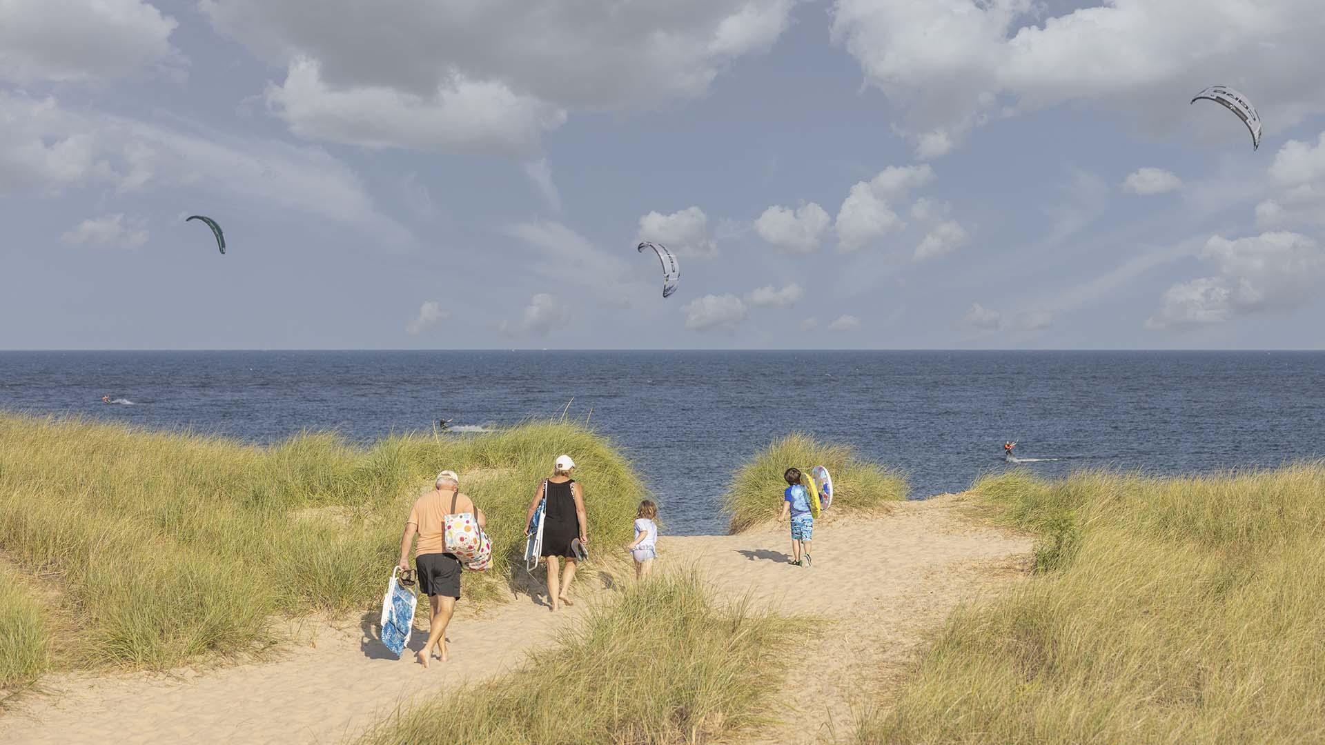 A family walking toward the beach in St. Joseph, MI