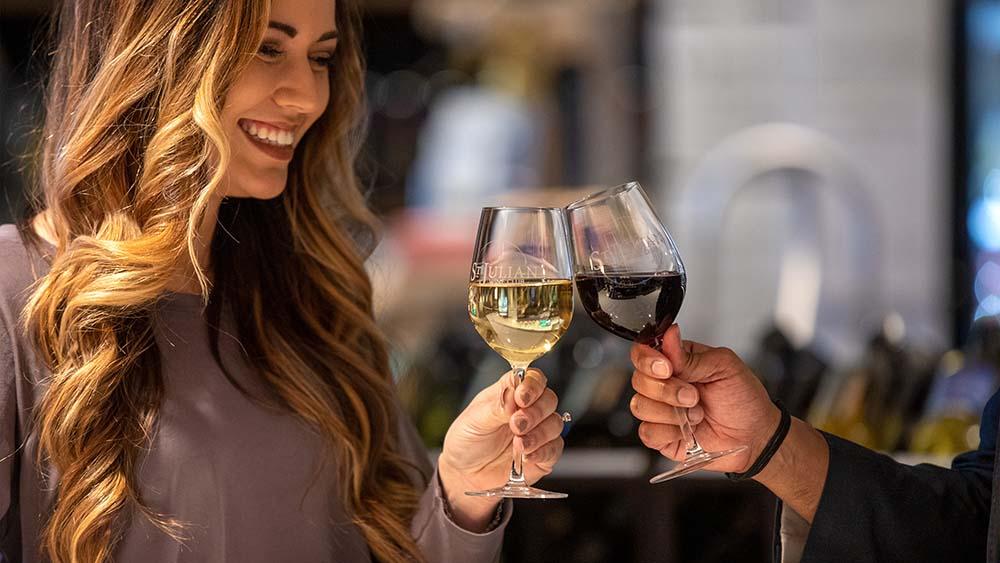 Two people with wine glasses at St. Julian