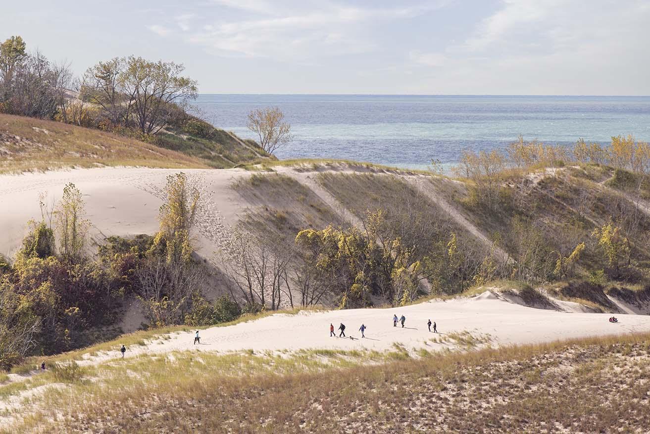 People climbing a dune at Warren Dunes State Park