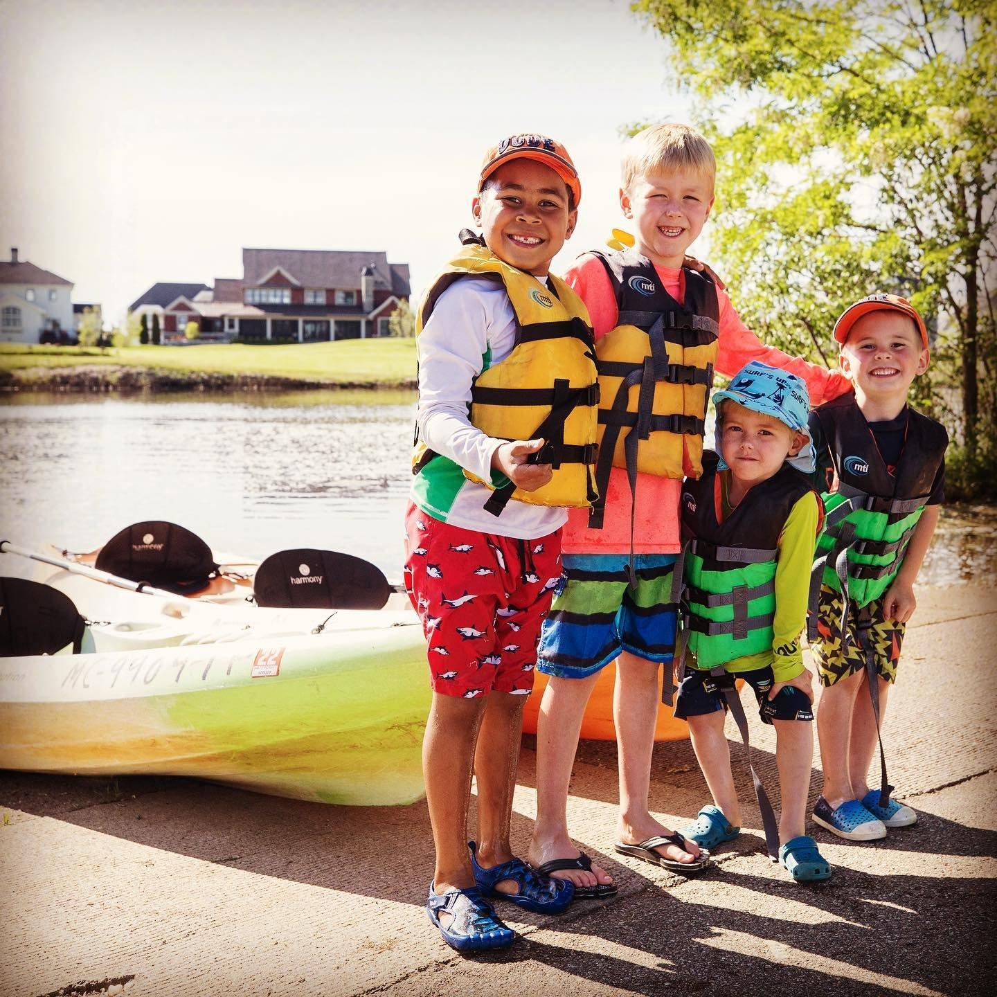 A group of kids getting ready to kayak.