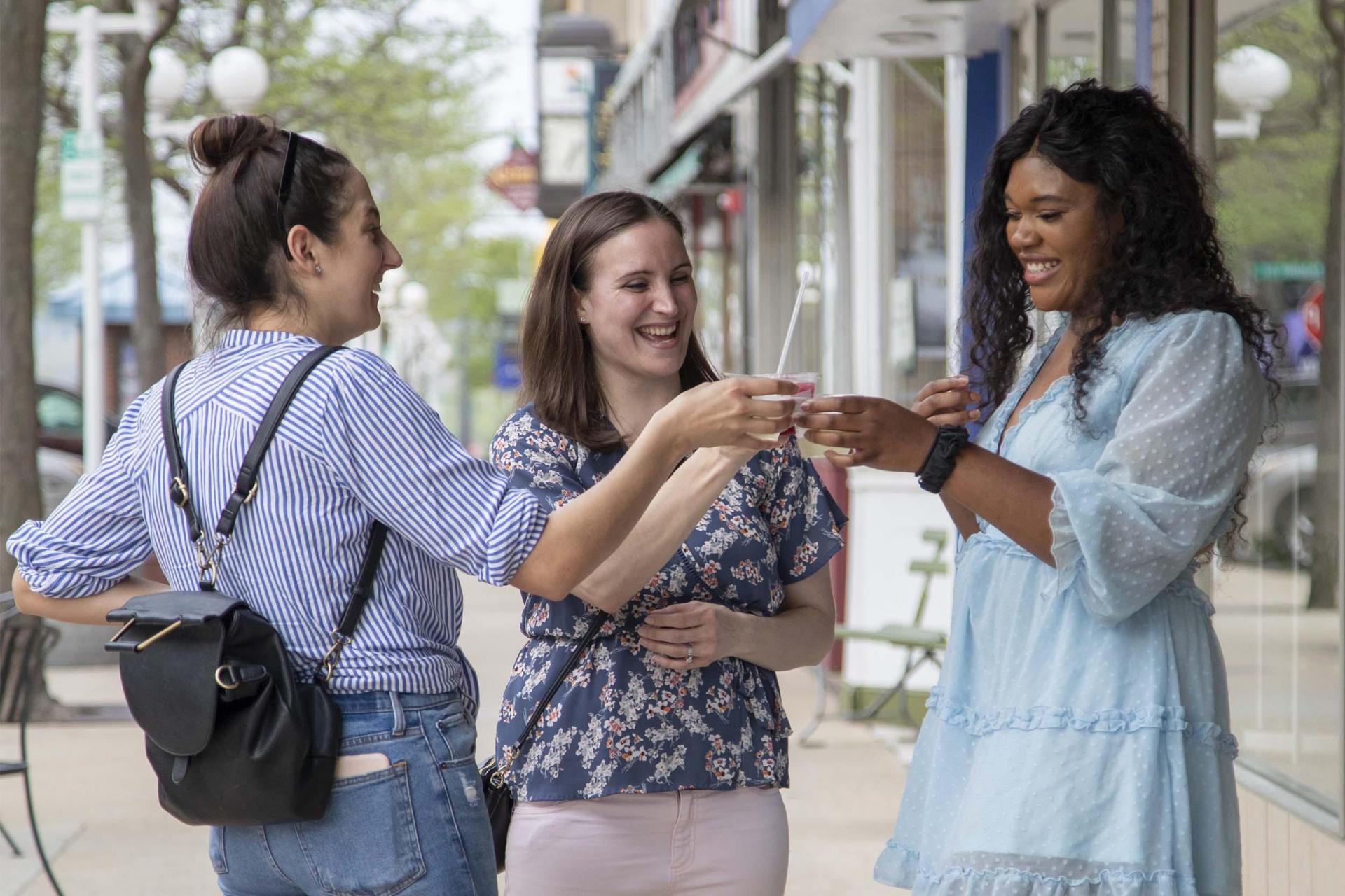 Three friend enjoying drinks in downtown St. Joseph.