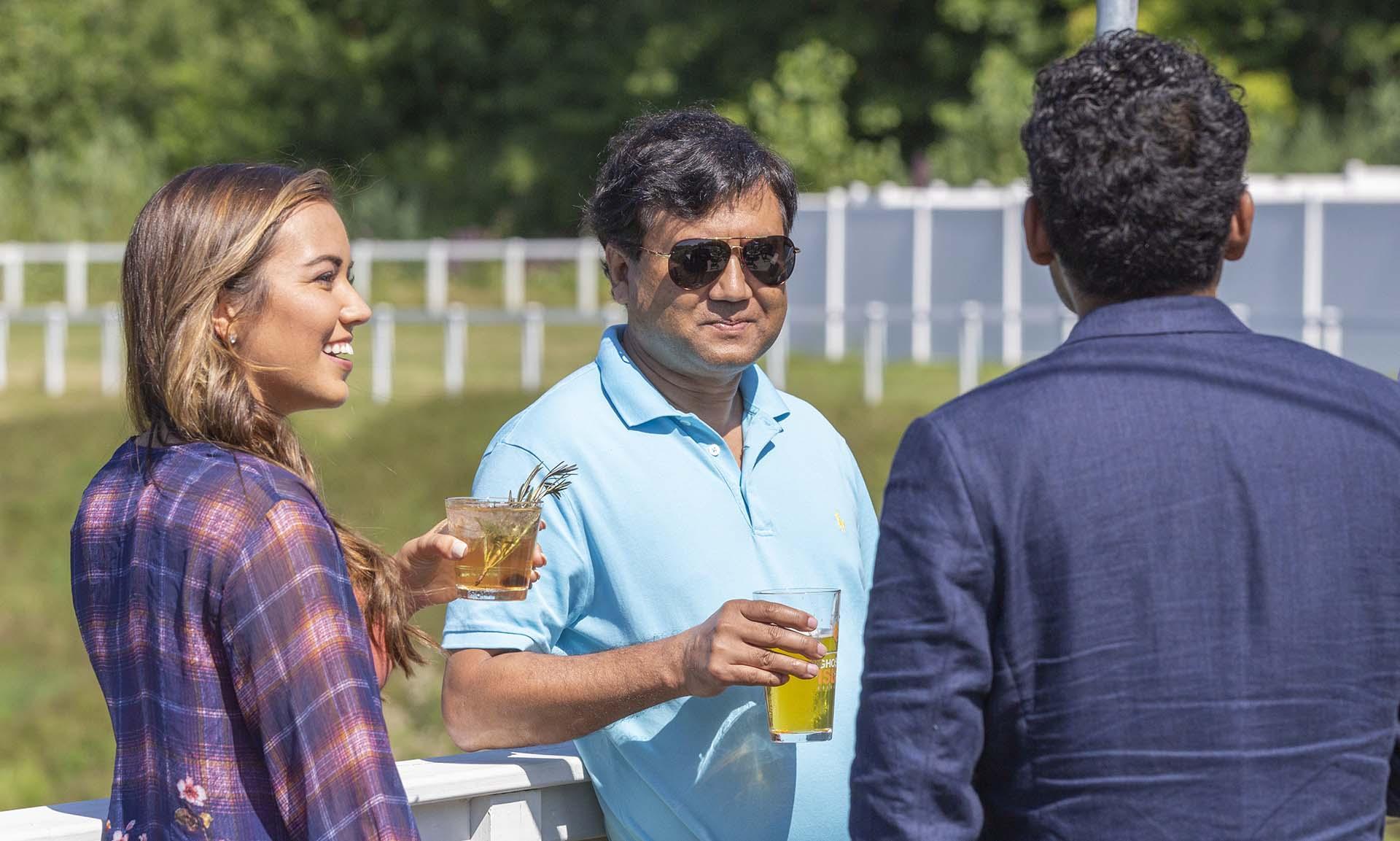 A group of people enjoying drinks outside