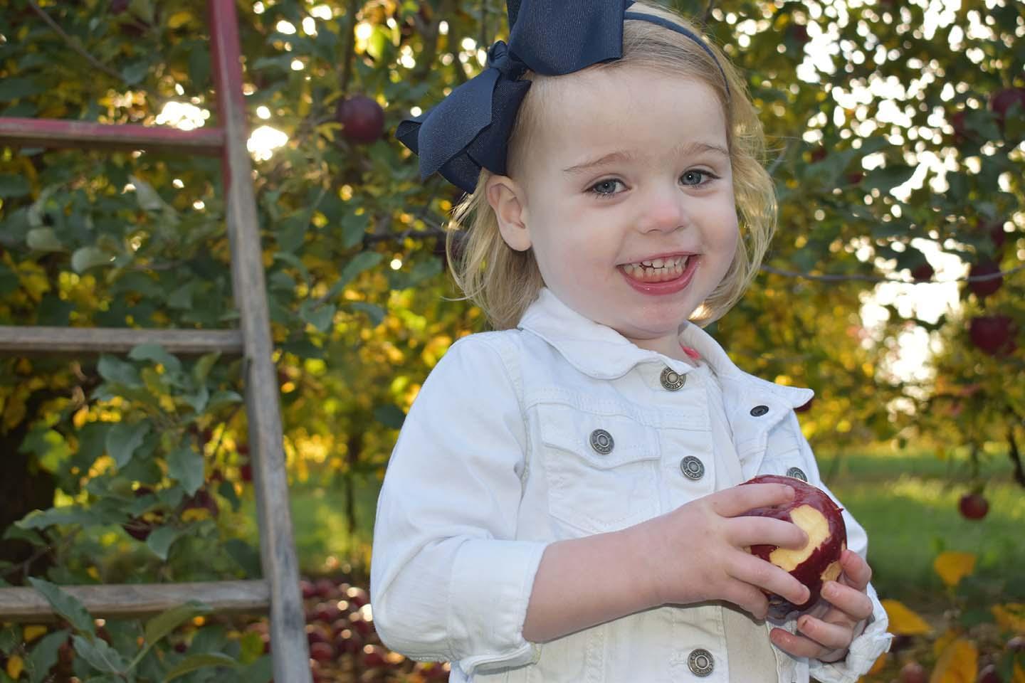 A child in the orchard at JW Morlock & Girls