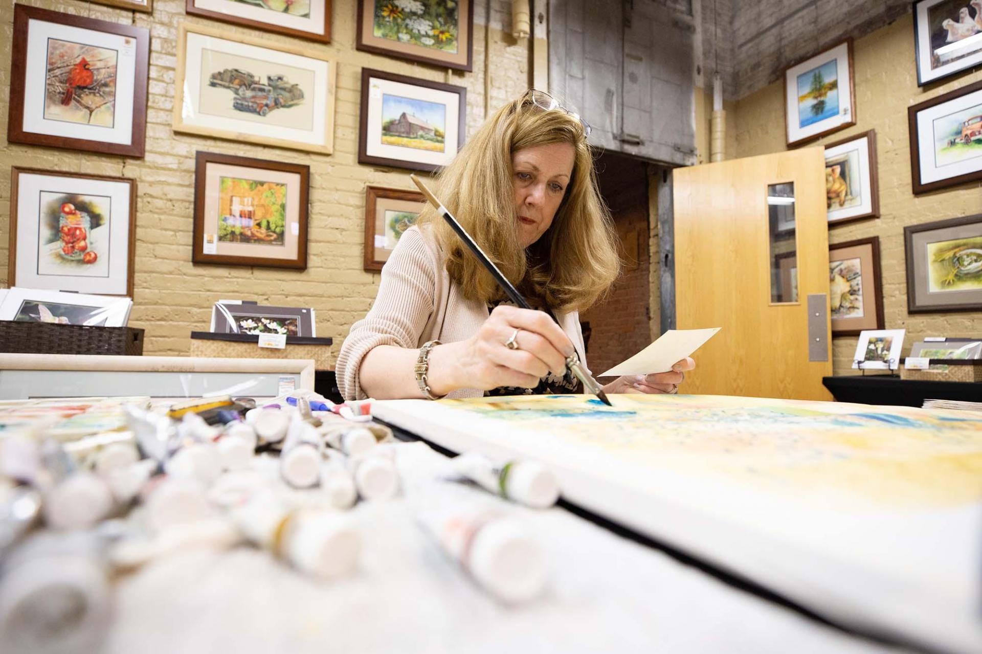 An artist painting at the Box Factory.