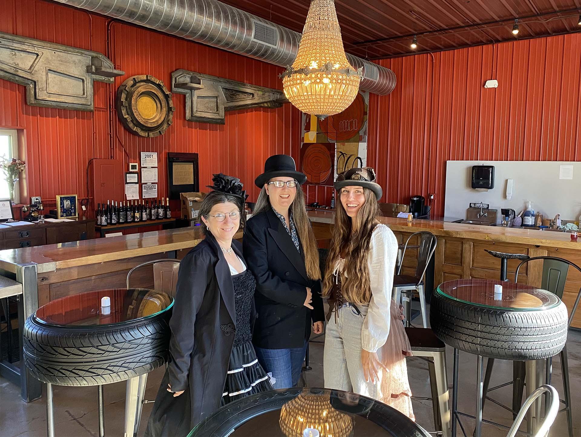 Three people posing for a photo at Golden Muse Winery