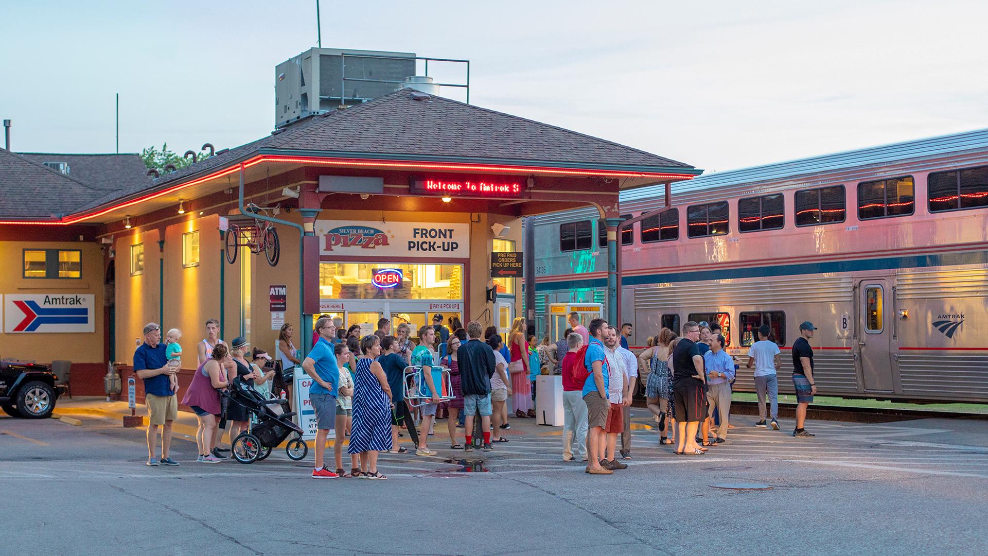 People waiting at the railroad crossing