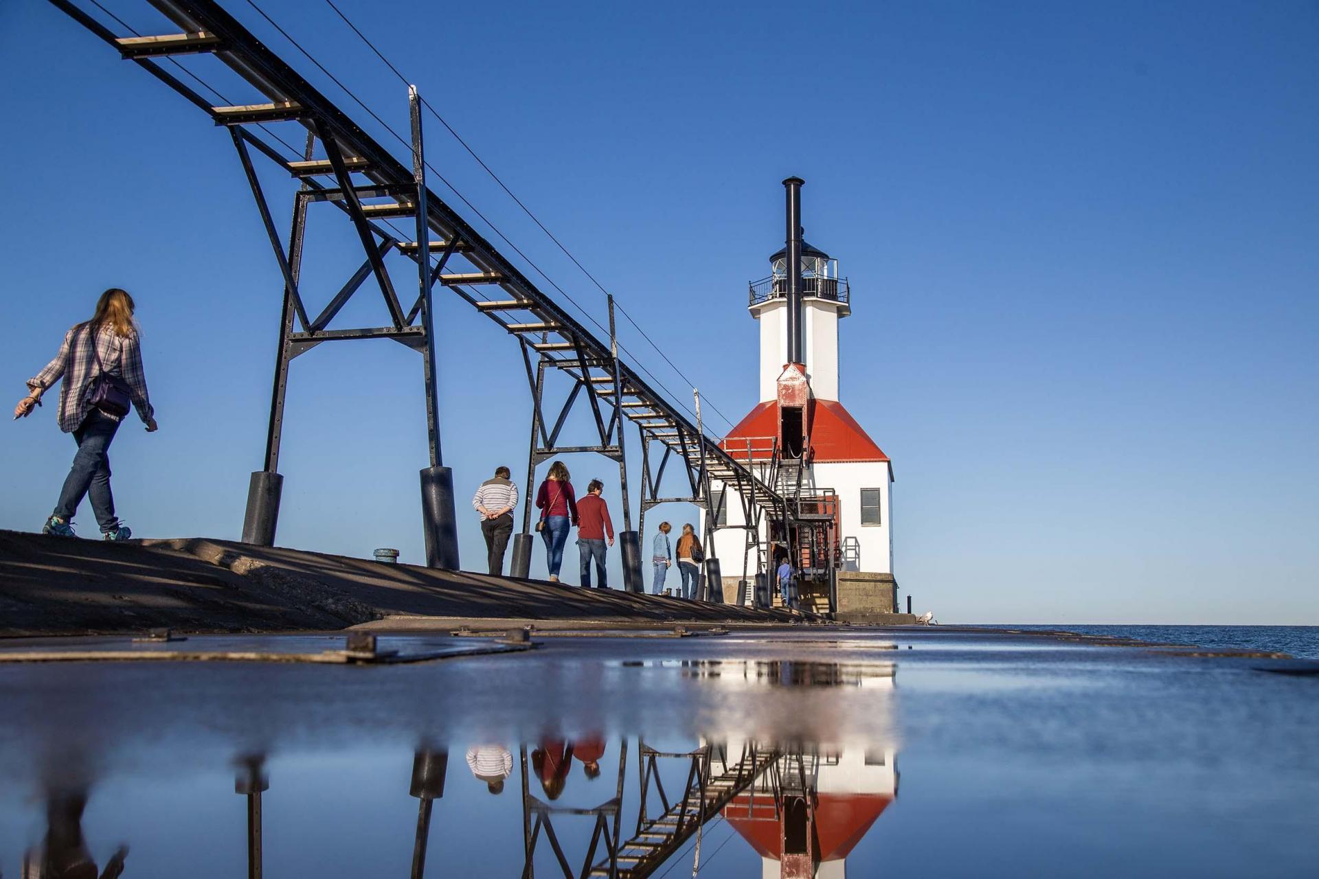 A group of people on a tour of the lighthouse in Saint Joseph.