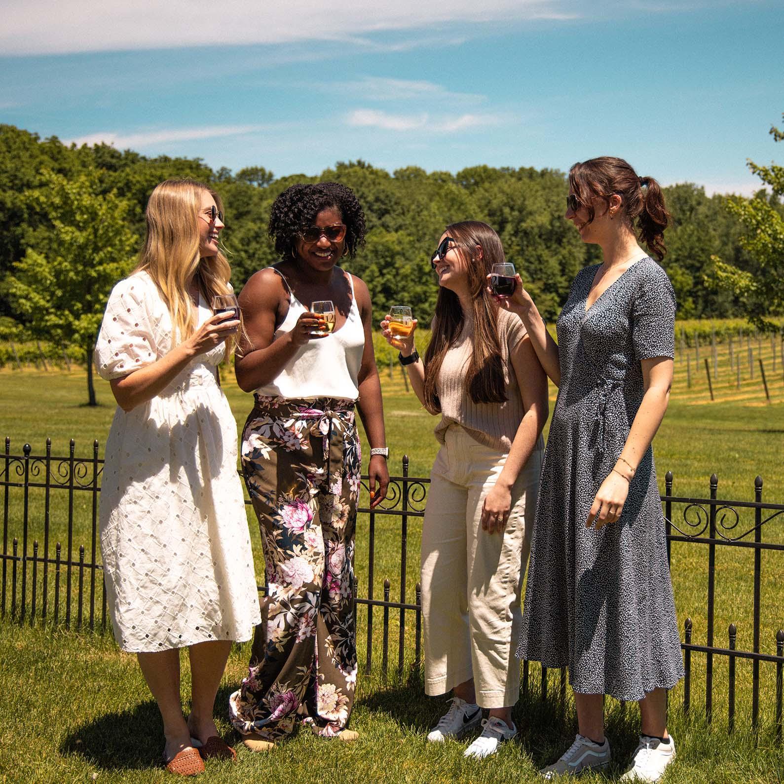 A group enjoying wine outdoors at 12 Corners Vineyards.