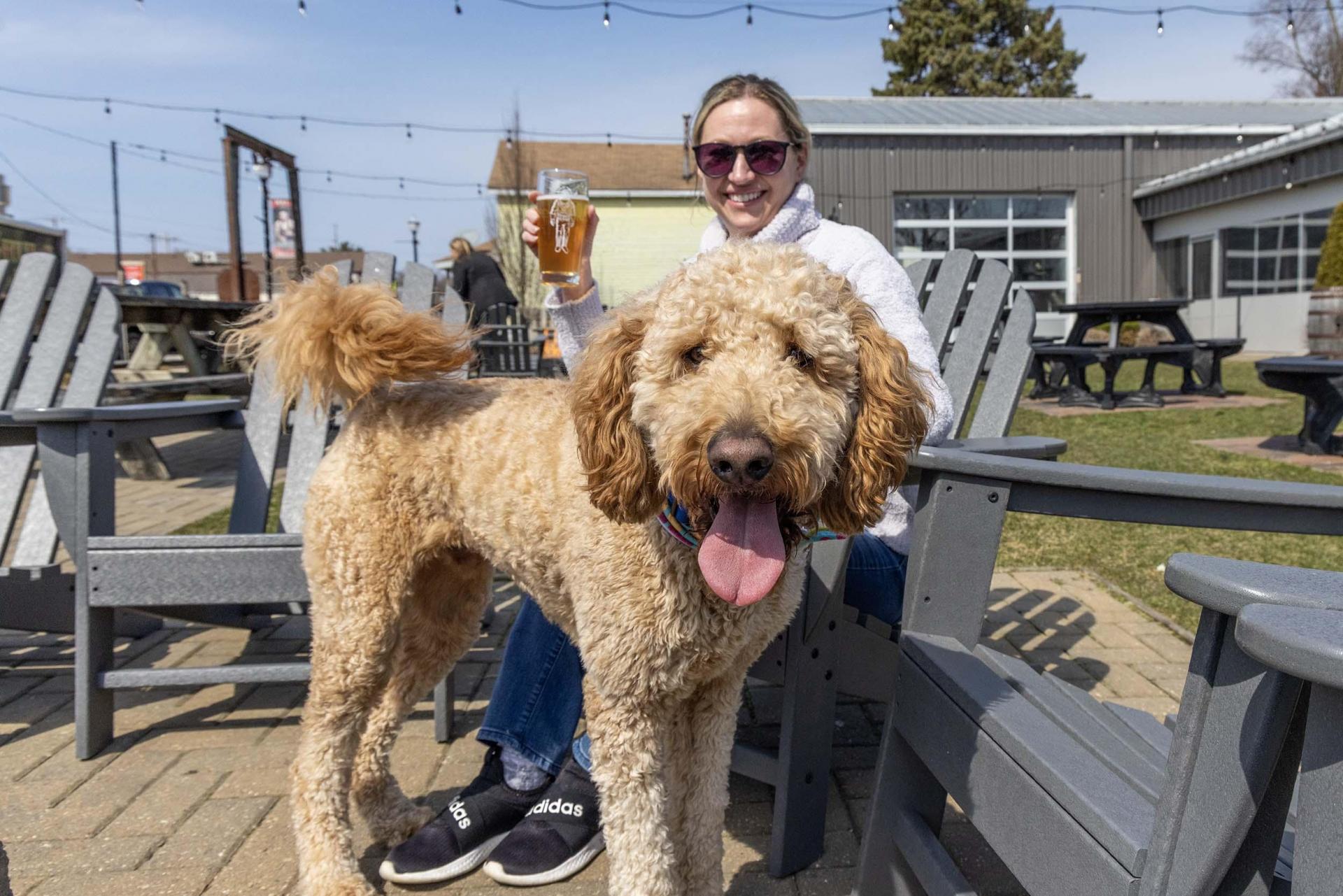 A person with a dog enjoying a drink at Watermark.