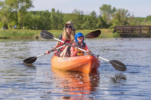 A mother and child kayaking the Paw Paw River.