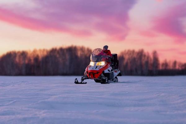 Snowmobile at sunset.
