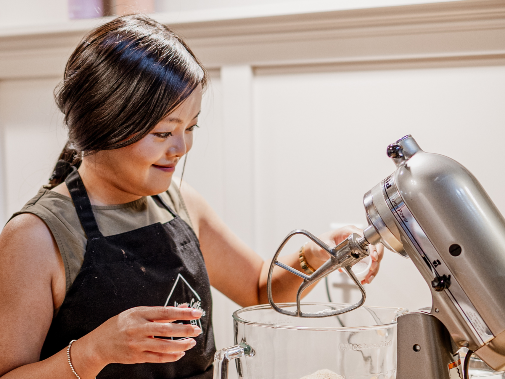 Rachel Kawate using a mixer at the Culinary Cottage cooking class