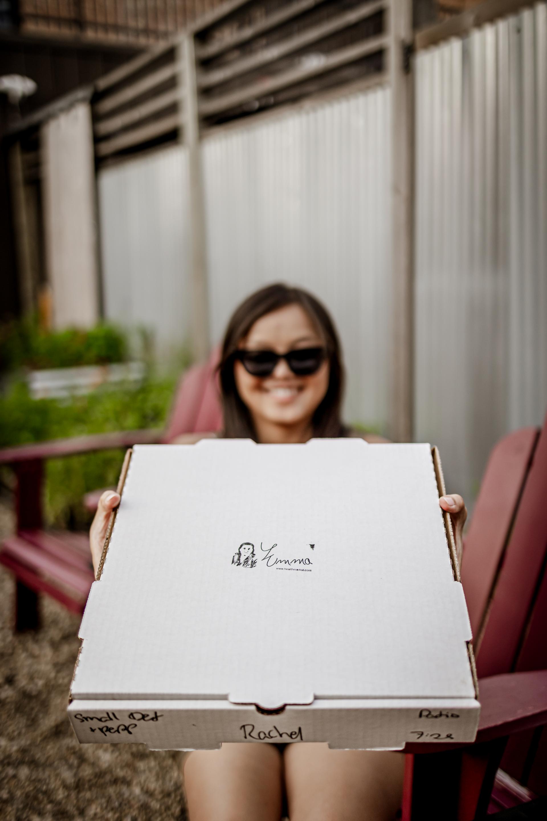 Rachel Kawate holding a pizza box