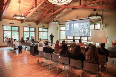A group listens in as a naturalist shares the rich history of Sarett Nature Center in the event room.