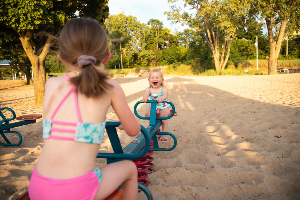 Two kids on a seesaw at lions park