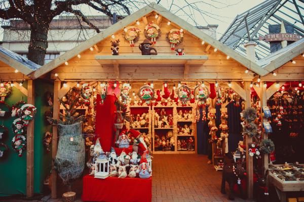 Inside christmas market with christmas lights and shopping