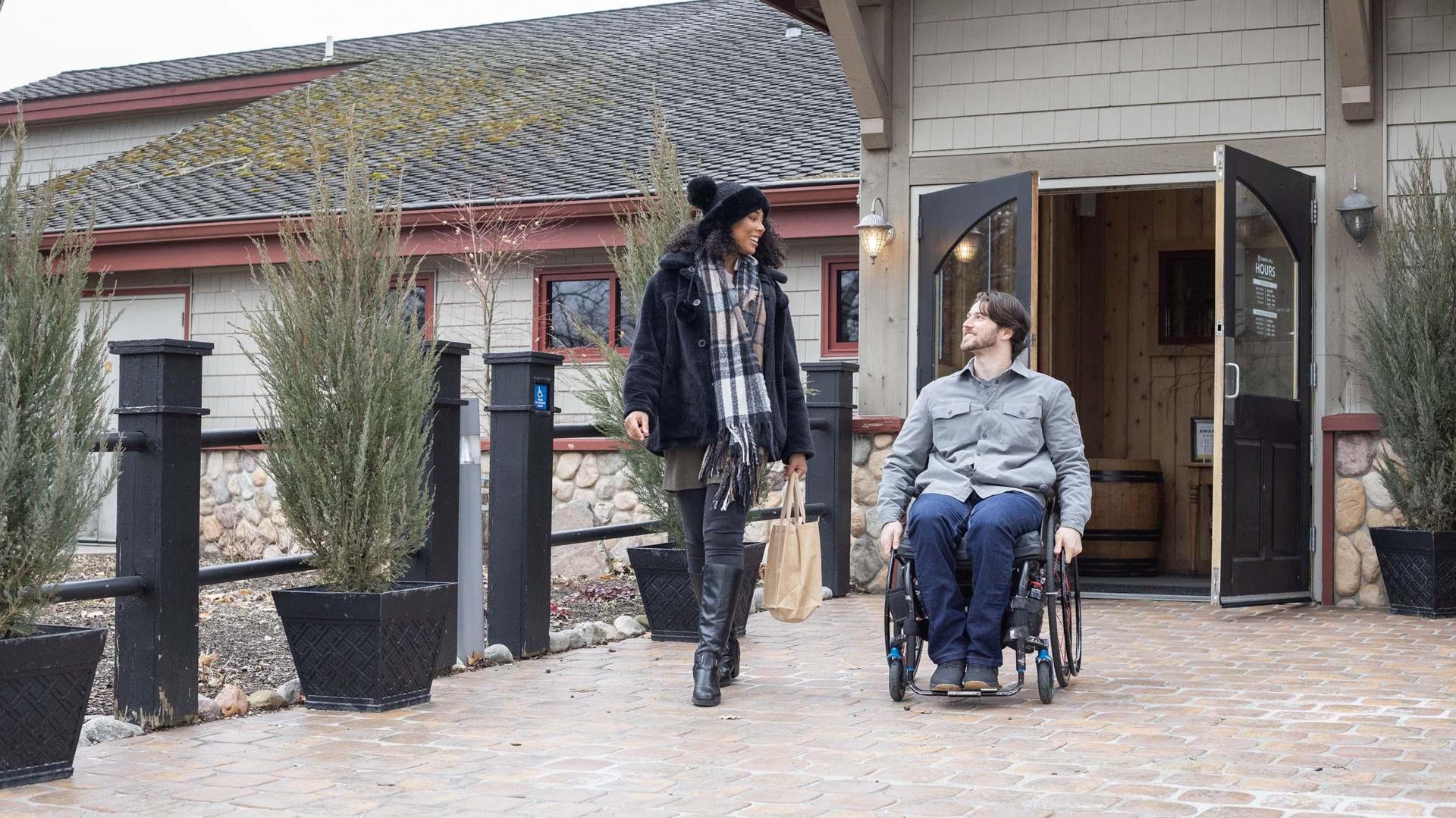 Two people in front of Tabor Hill Restaurant. 