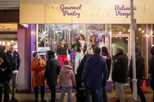 Community Members Posed Perfectly Still, Like Mannequins, In Downtown Business Window