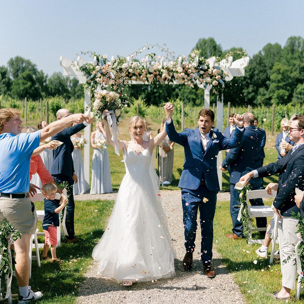 A couple celebrates their outdoor wedding at Tabor Hill Winery & Restaurant.