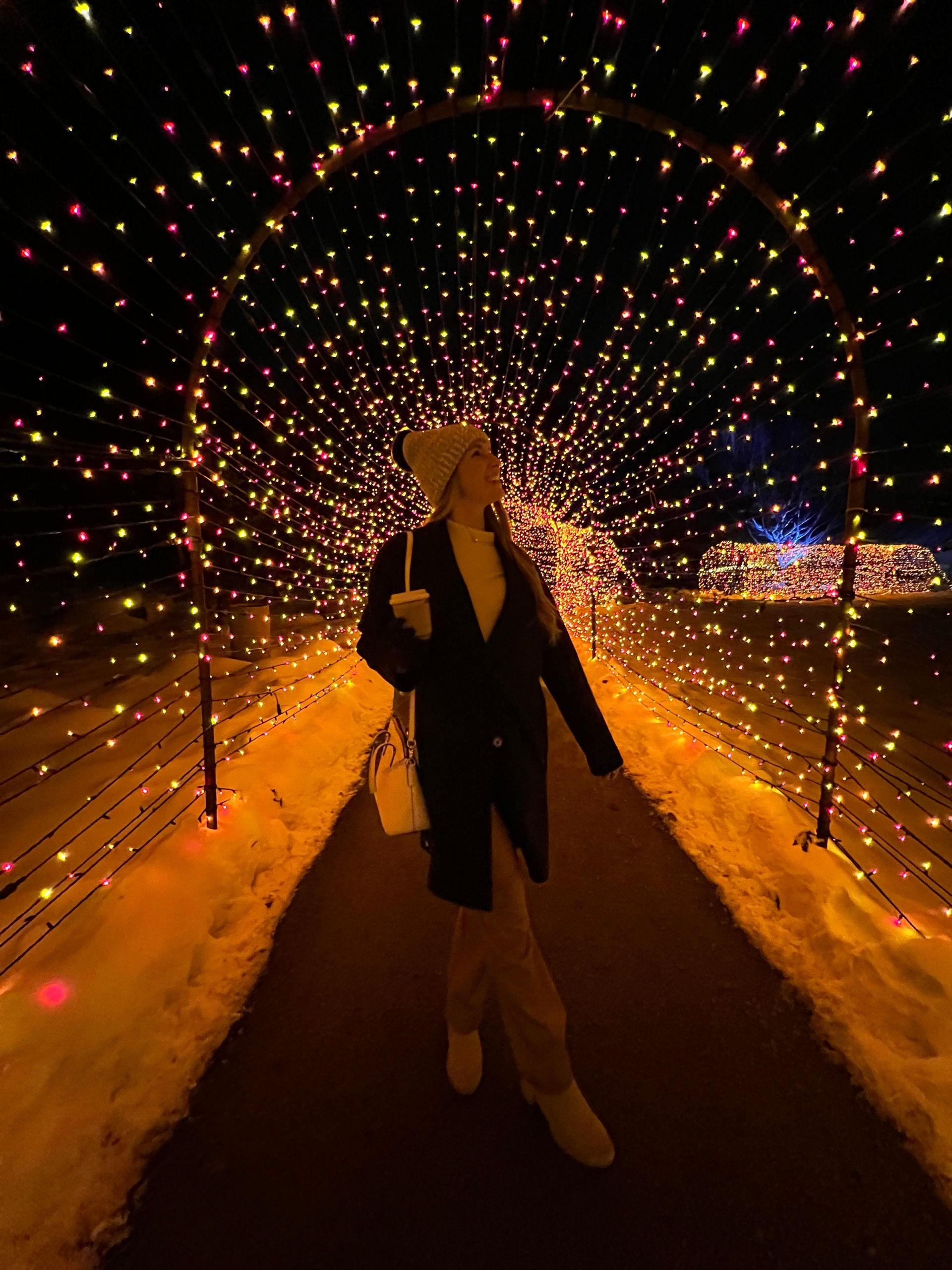 Lydia Knoll enjoying a festive evening among the Christmas lights at Fernwood Botanical Garden.