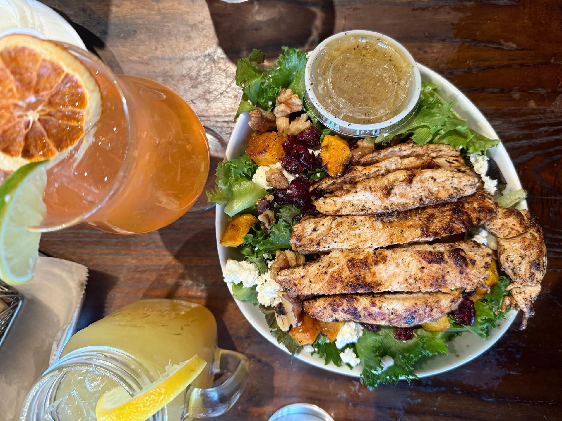 A salad with chicken and cocktails at Iron Shoe Distillery