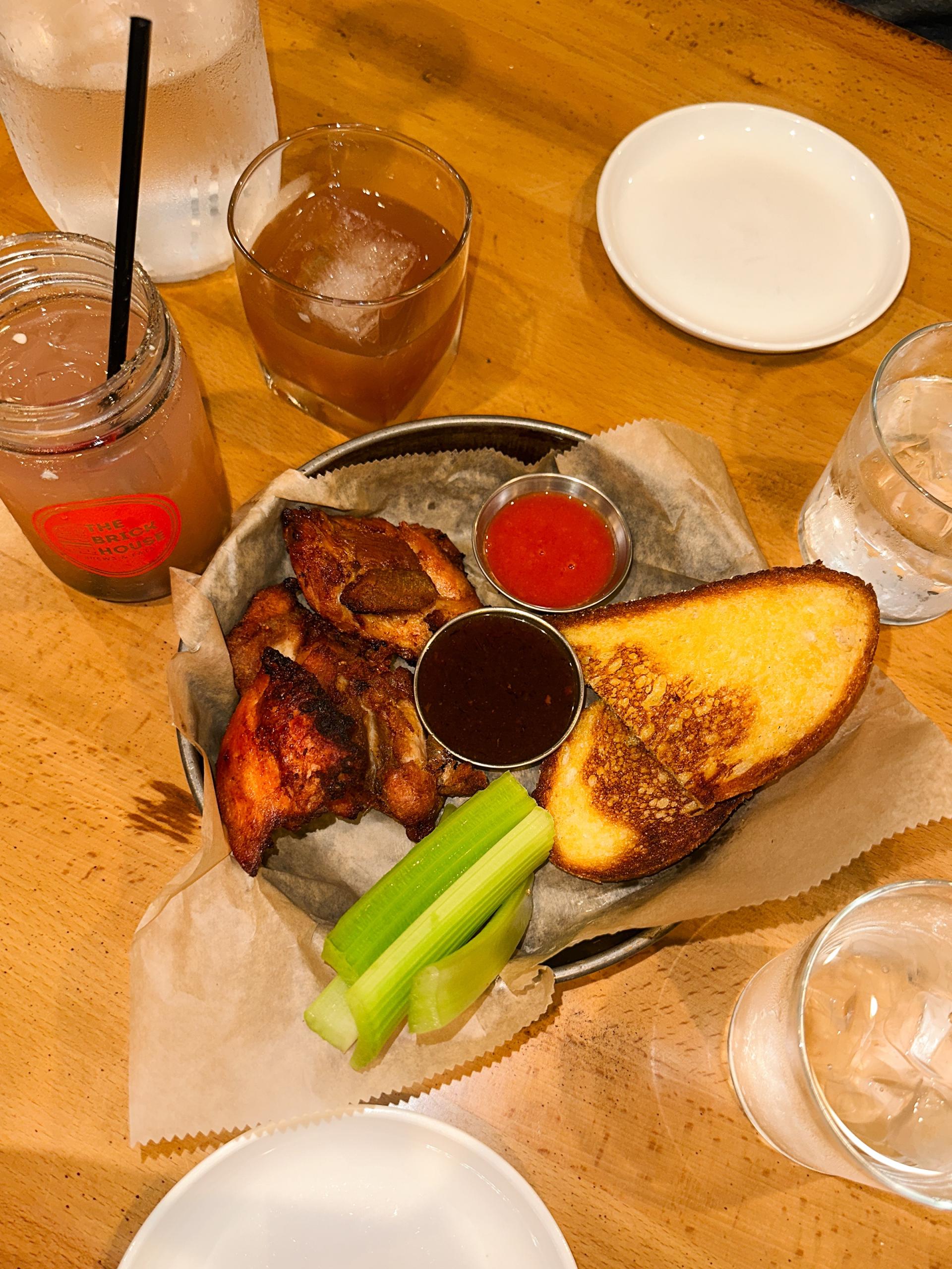 Cocktails and food on a table at The Brick House.