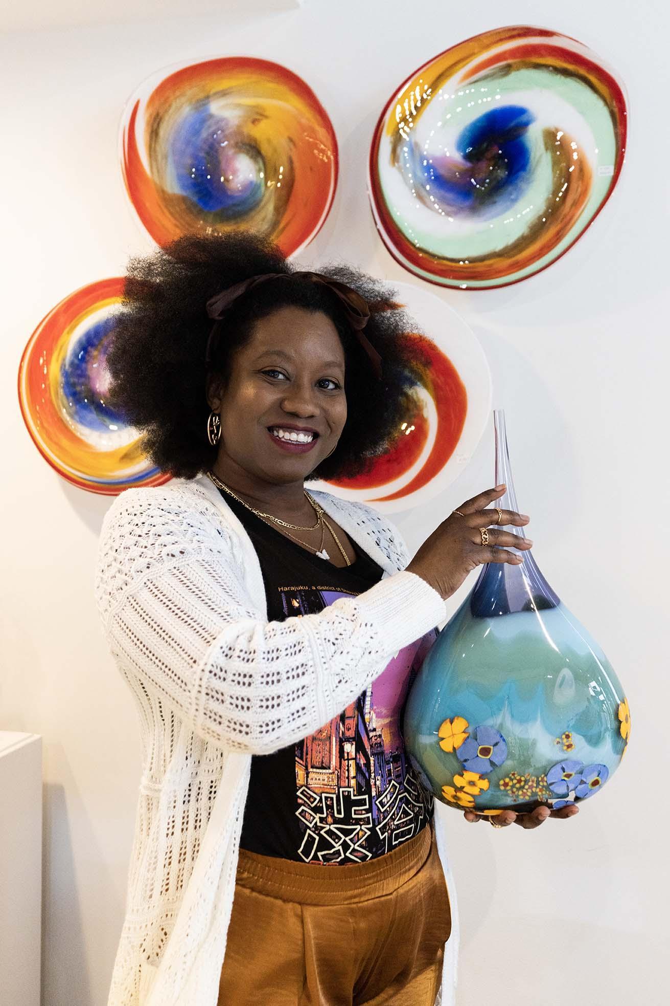 A person holding artwork at Water Street Glassworks.