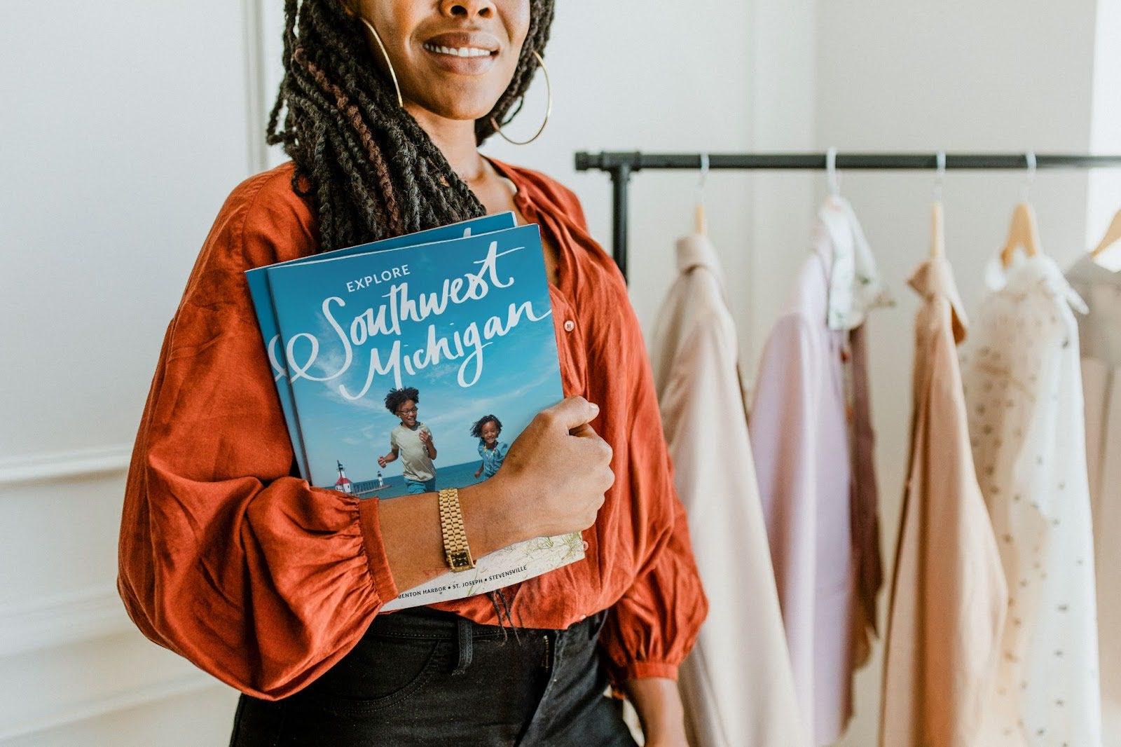 A Woman holding the Visit Southwest Michigan Visitors Guide
