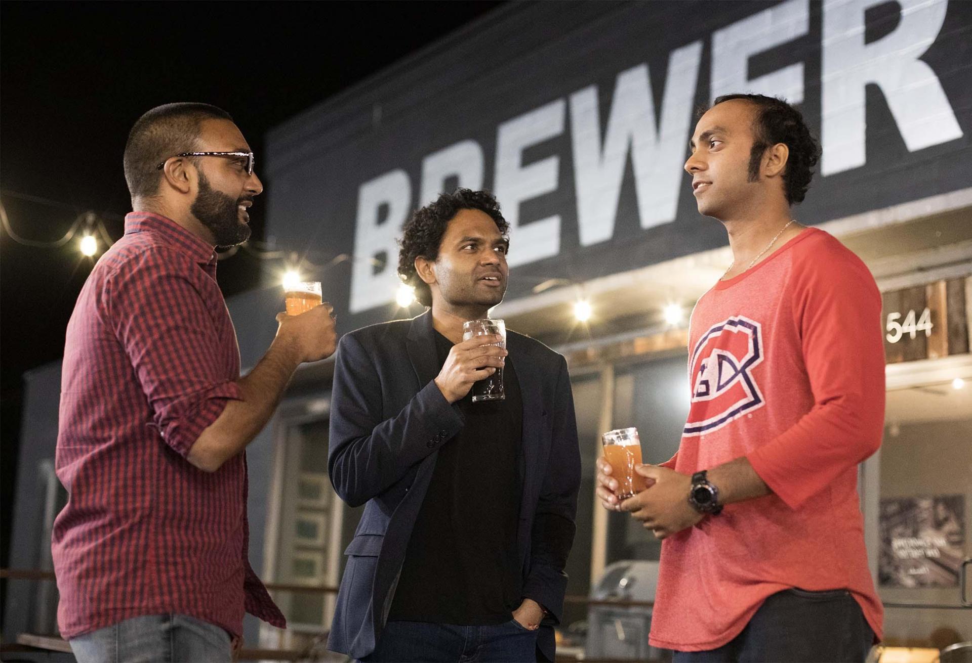 Three people enjoying beers at Arclight