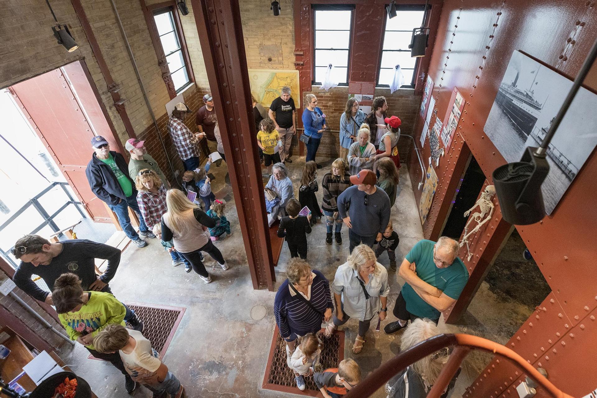 Visitors gather inside the lighthouse as they await a guided tour.