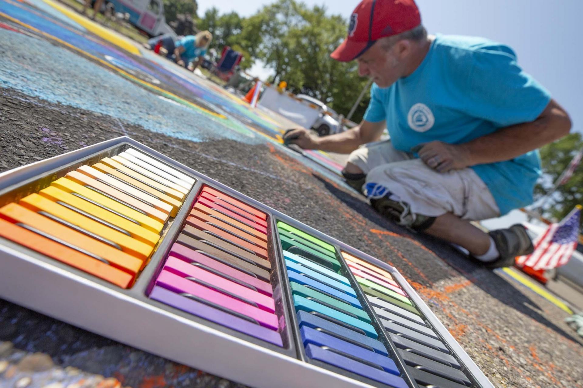 An artist at work at Chalk The Block.