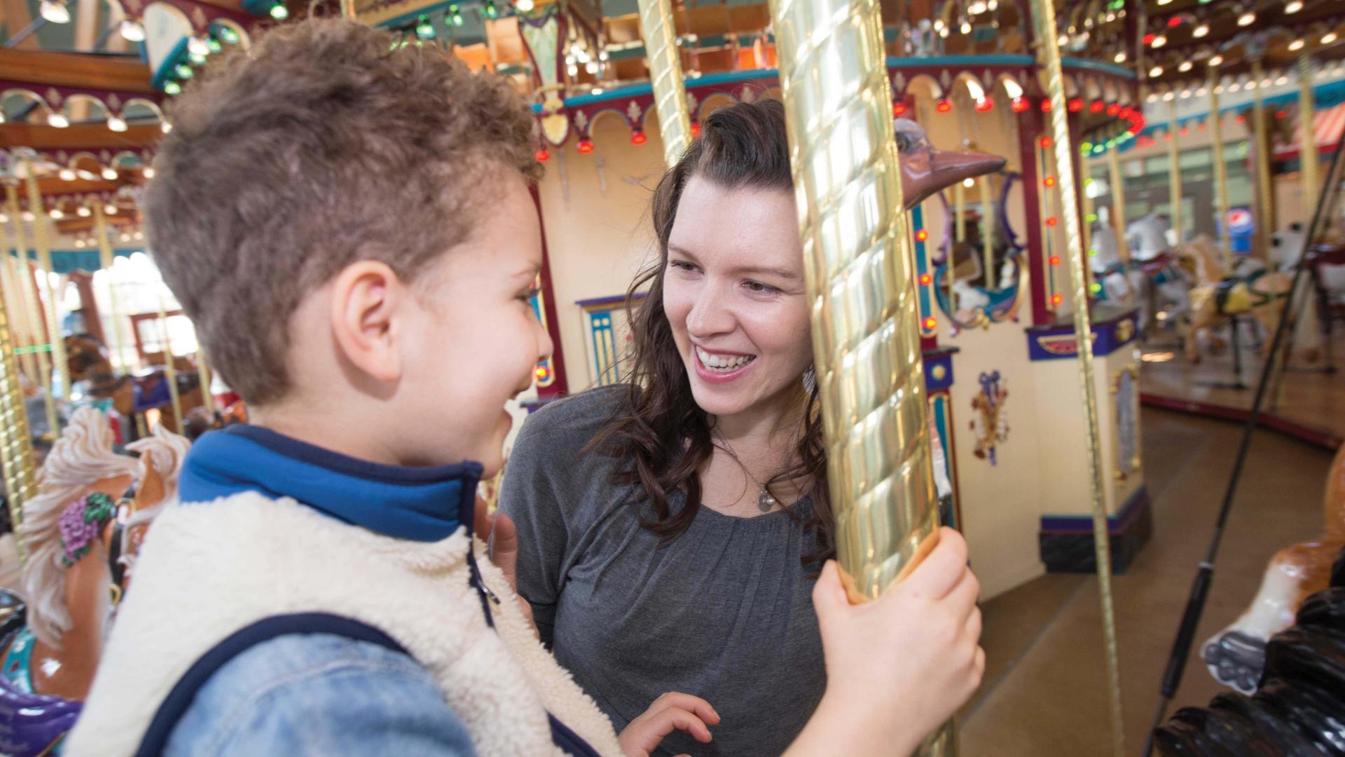 A mother and child at the Silver Beach Carousel.