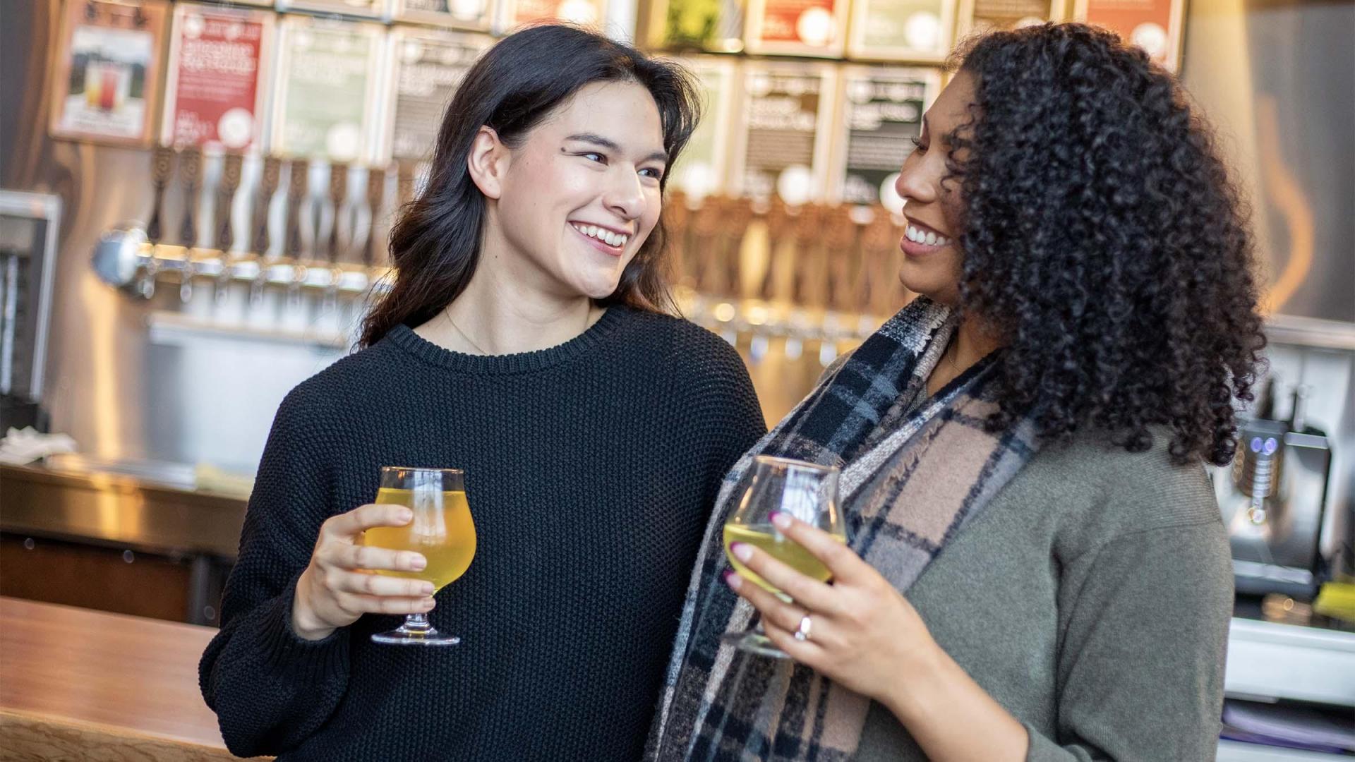 Two people enjoying drinks at River Saint Joe