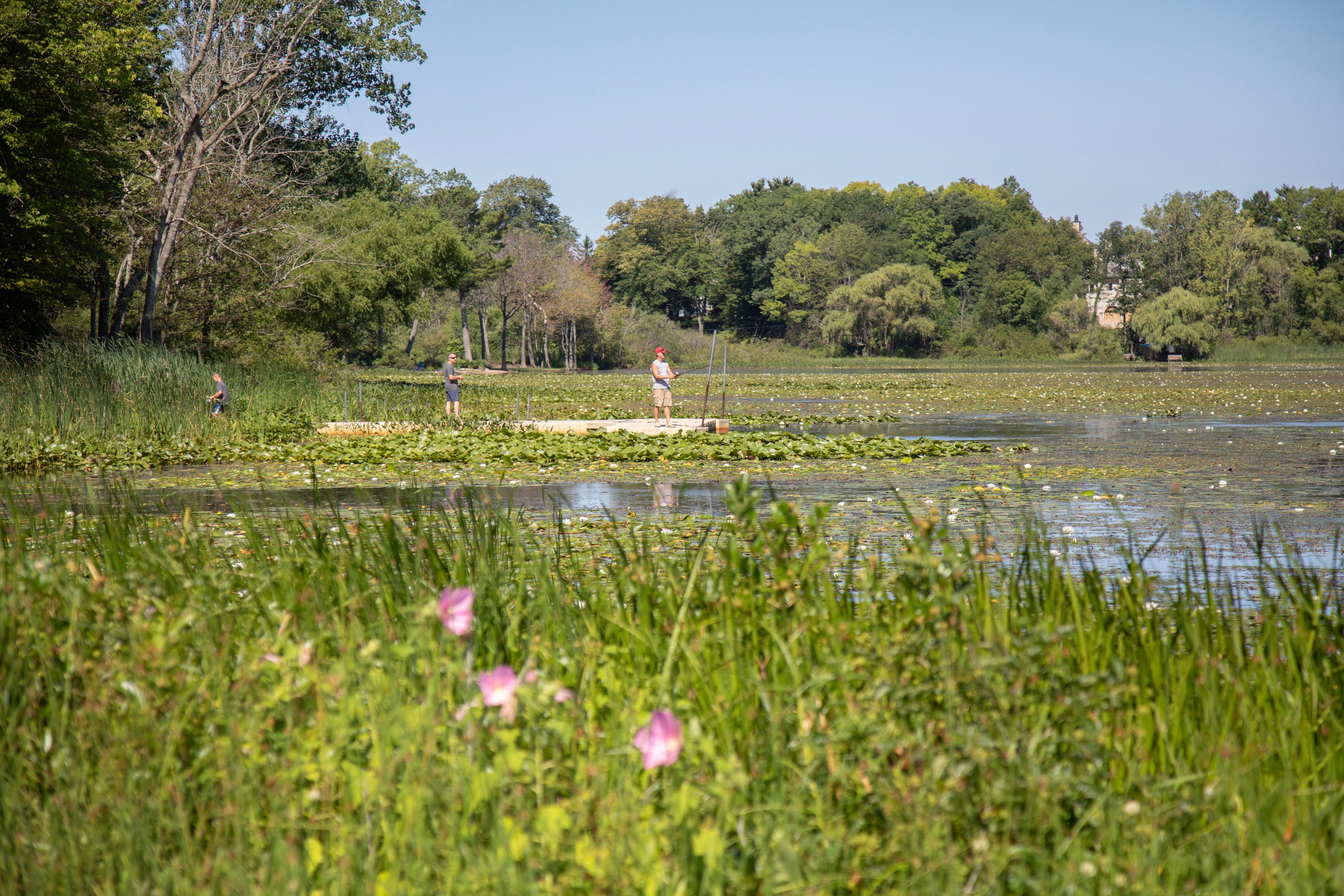 People fish from the dock at North Lake Park.