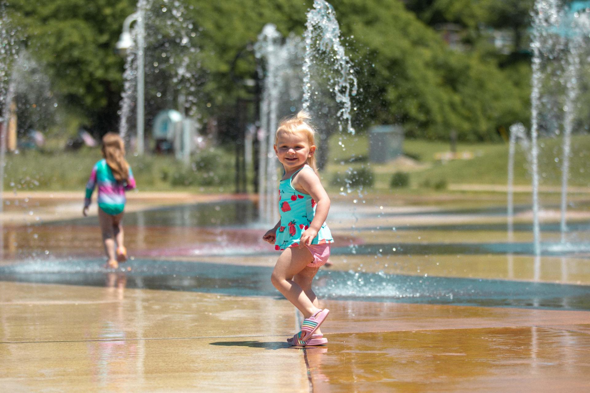 A child playing in the Whirlpool Compass Fountain.