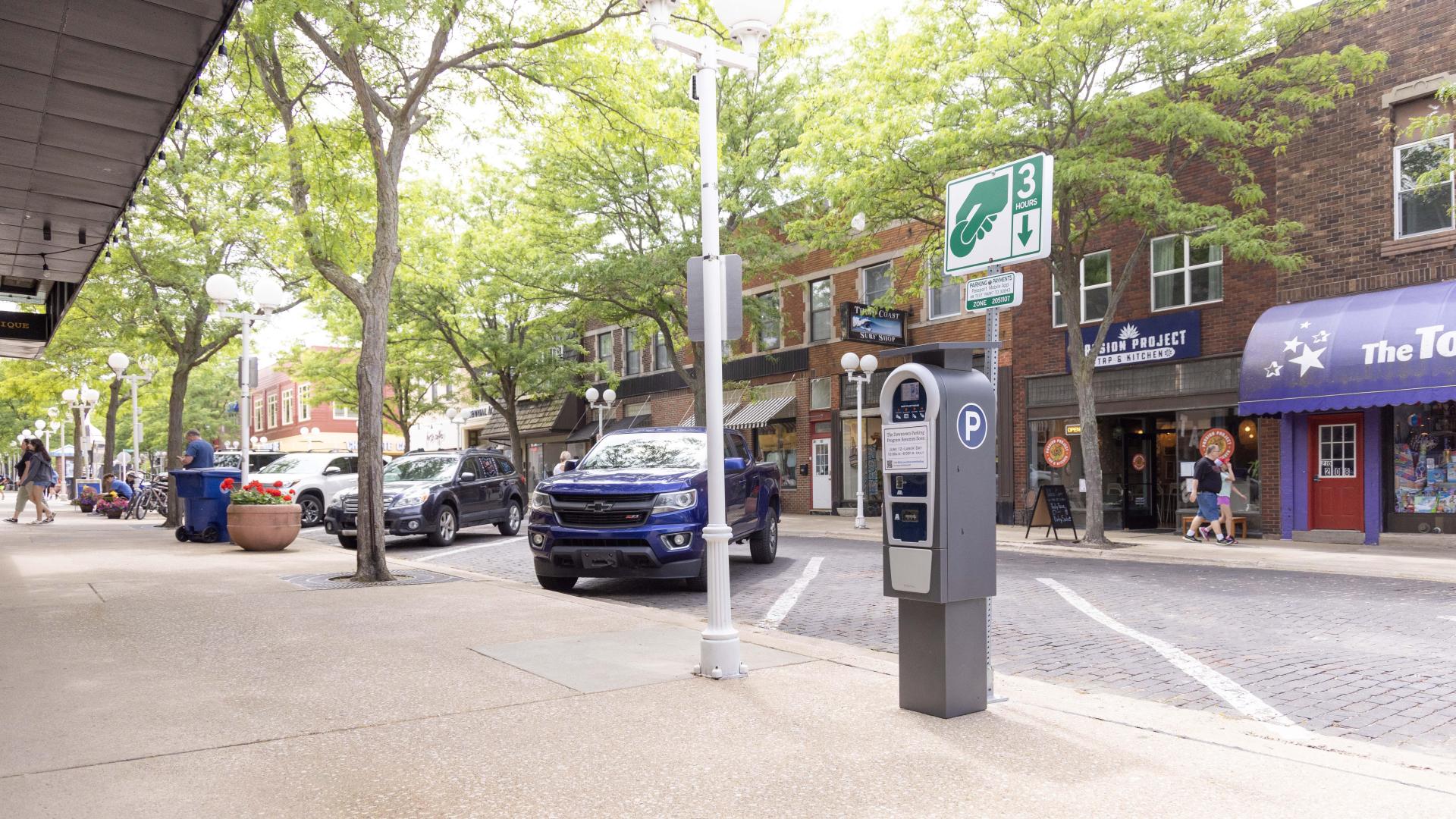 A parking meter stands along a downtown street in St. Joseph, Michigan, on a lovely summer day.