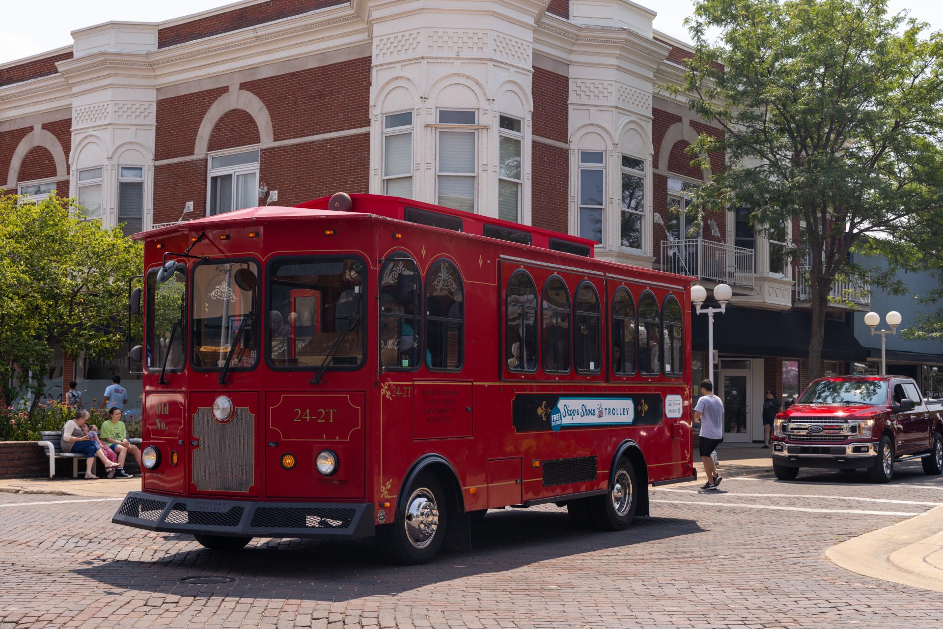 A trolley makes its way through downtown St. Joseph on a sunny summer day.