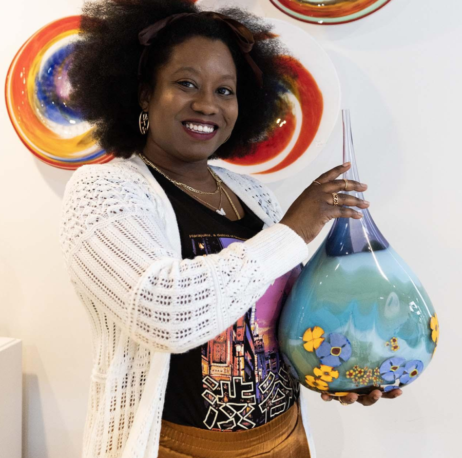 A person holding artwork at Water Street Glassworks.
