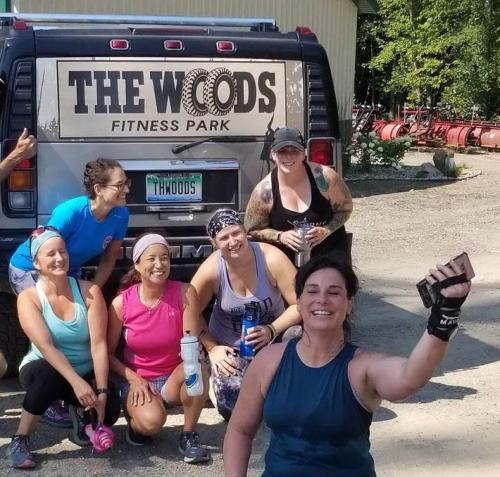 A group of people posing for a photo at The Woods: Fitness Park.