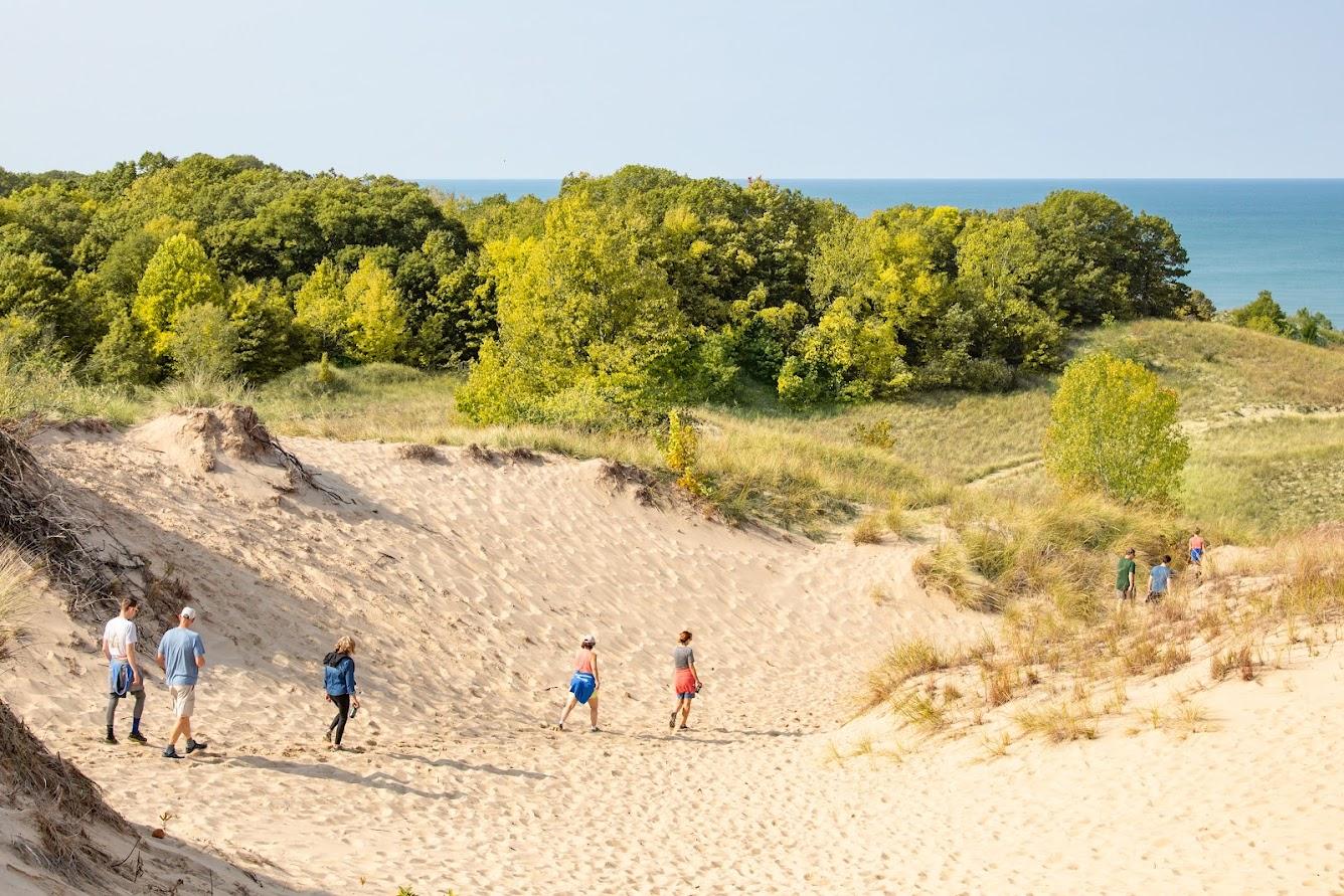 People hiking at Warren Dunes State Park in the spring