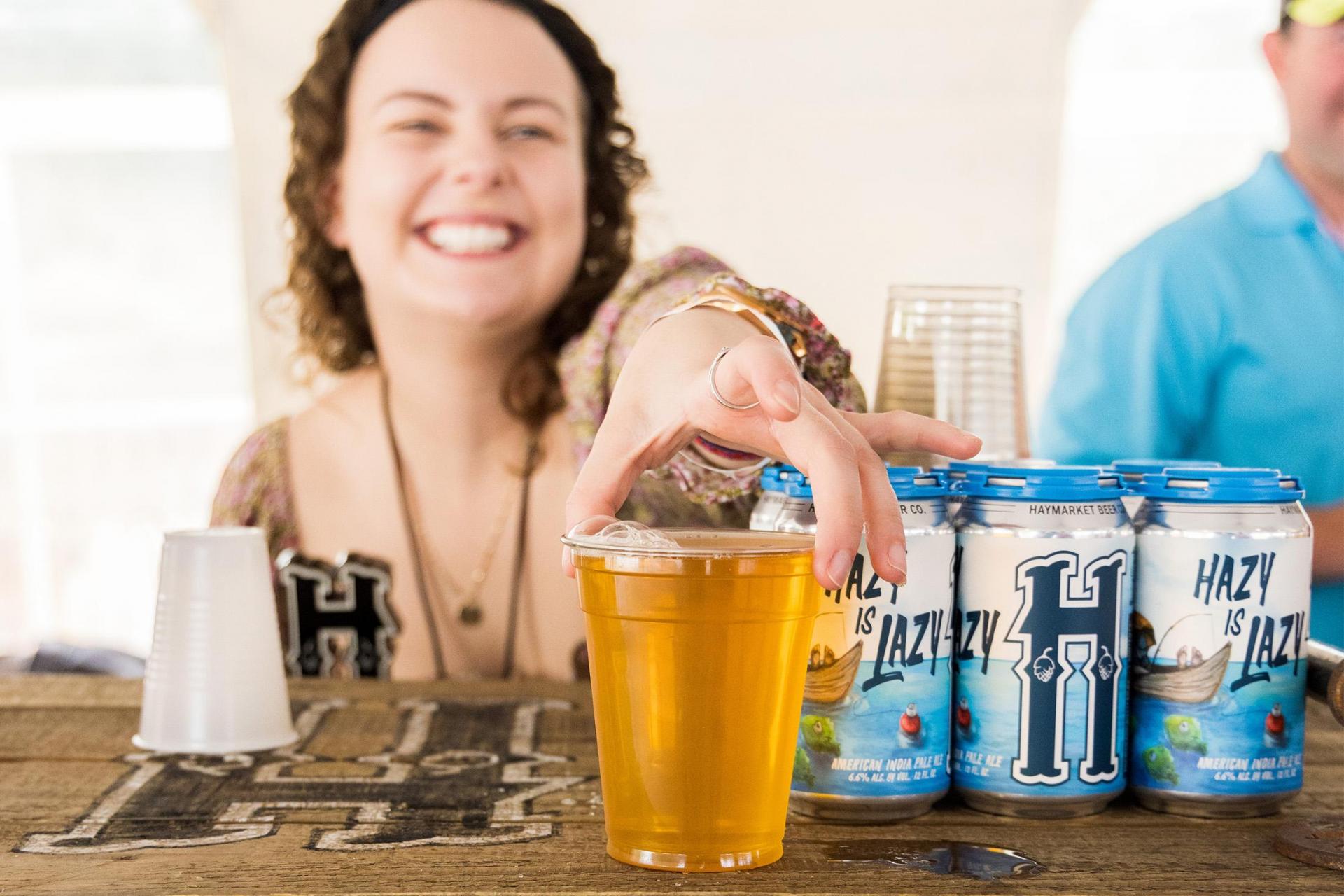 A volunteer serving beer at the Makers Trail Festival.