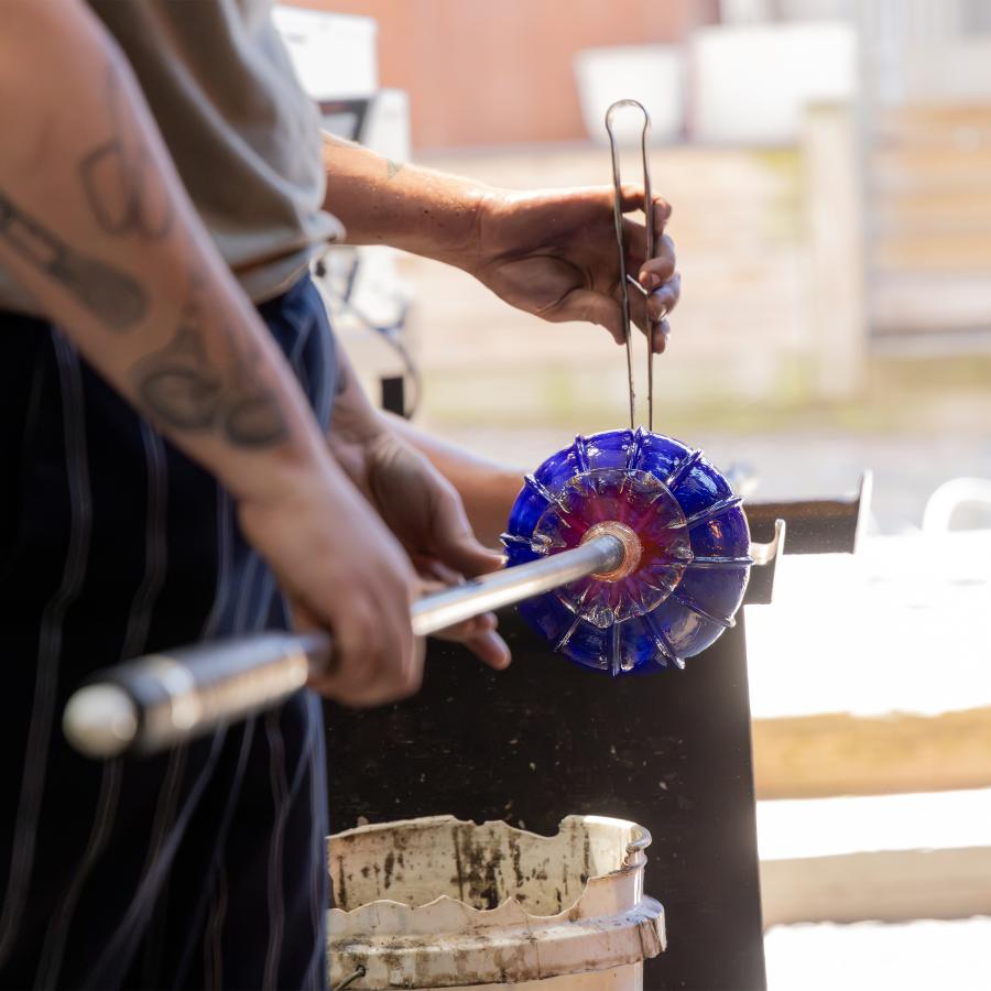 Two workers creating a piece at Water Street Glassworks