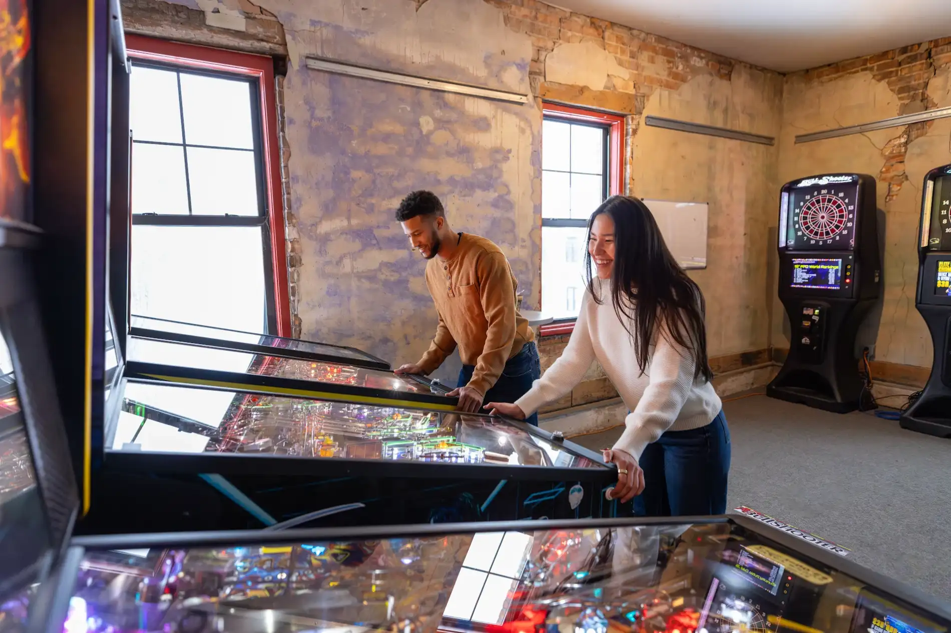 Couple playing pinball