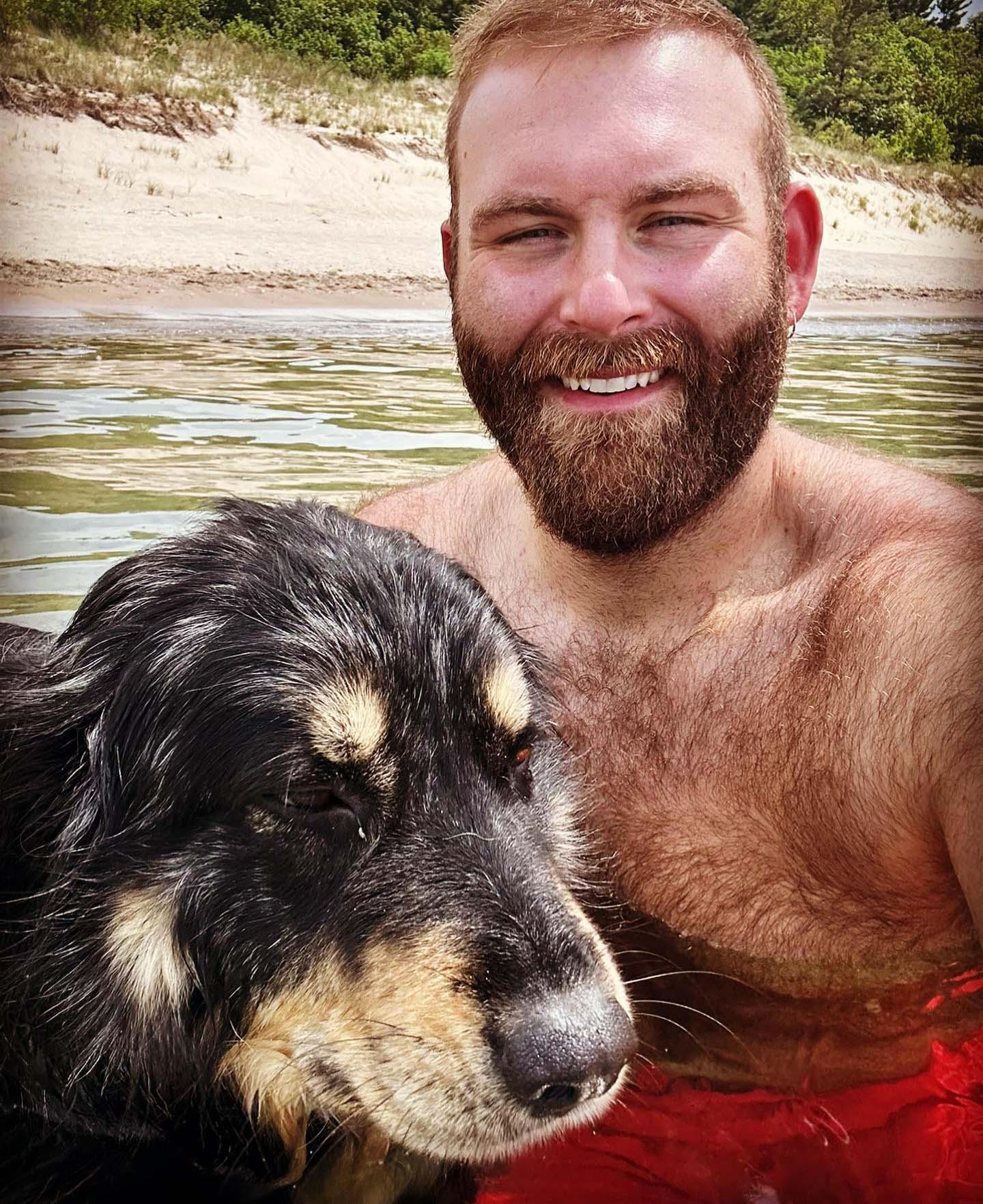 A person and a dog in the water at Warren Dunes State Park. 