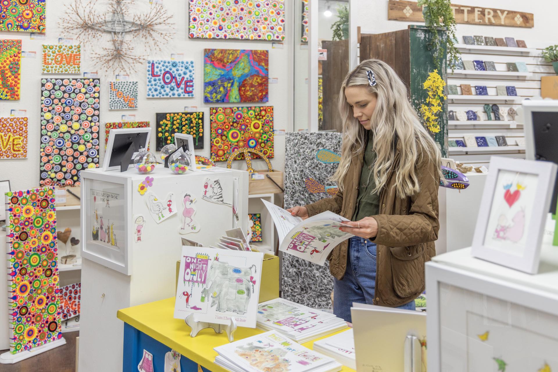 Woman looking at a book in a shop
