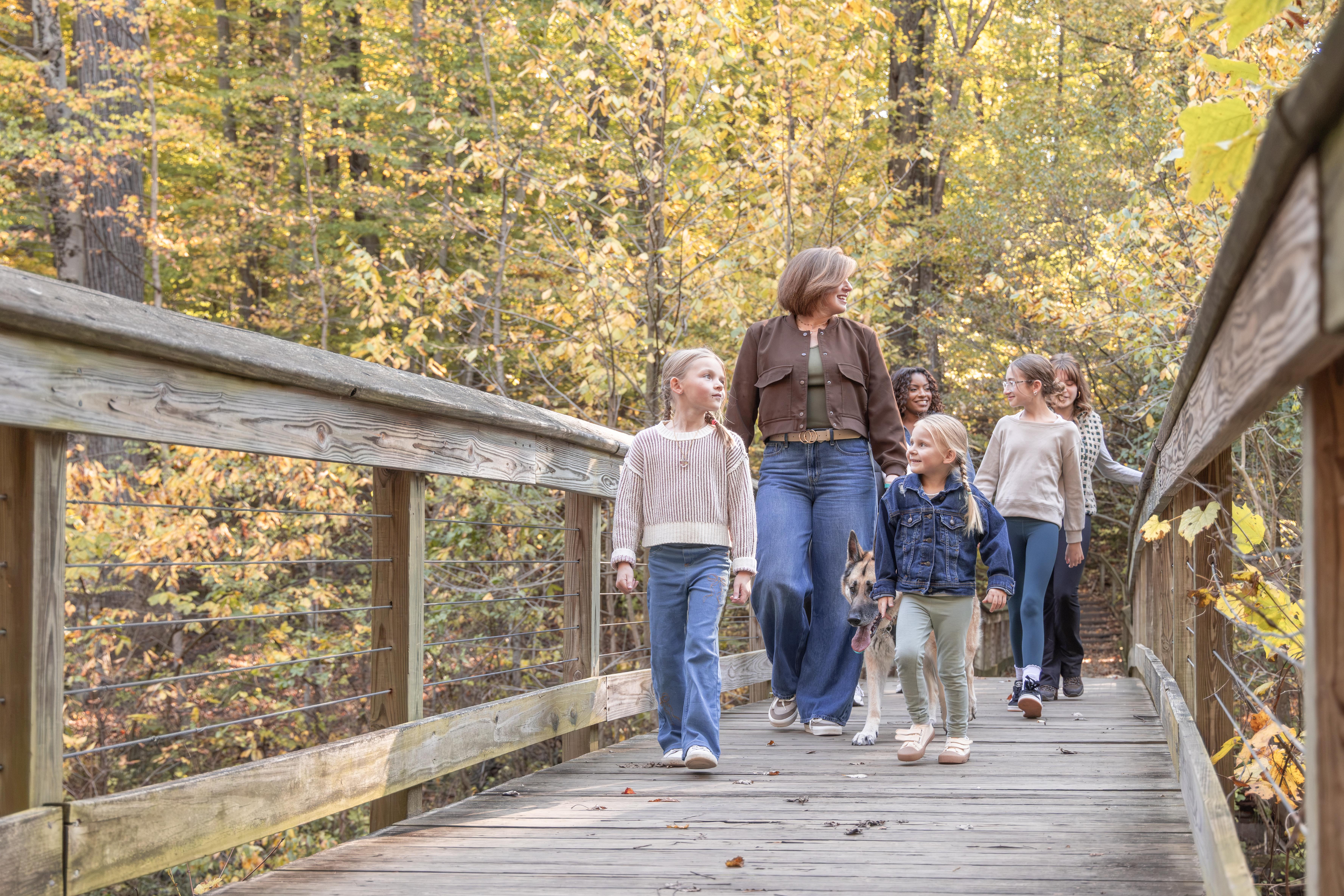 A group of hikers enjoying a scenic stroll through Warren Woods State Park on a beautiful fall day.