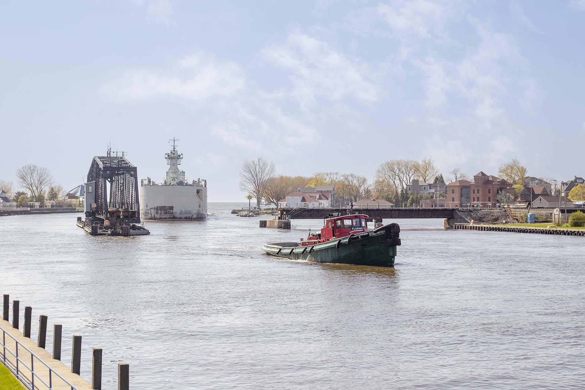 A barge and boat in the St. Joseph River. 