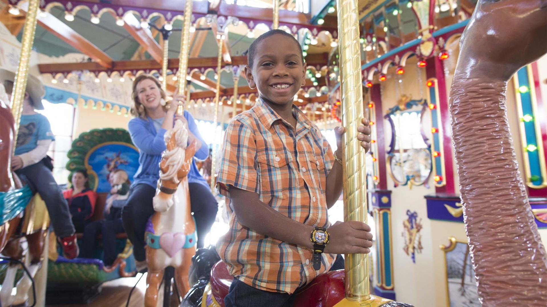 A family enjoying a ride on the Silver Beach Carousel.
