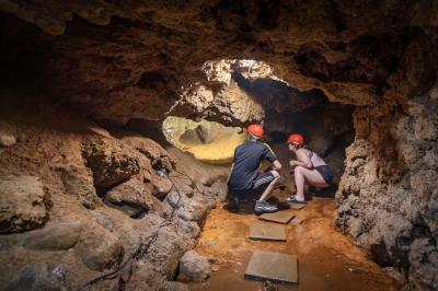 Two people exploring Bear Cave.